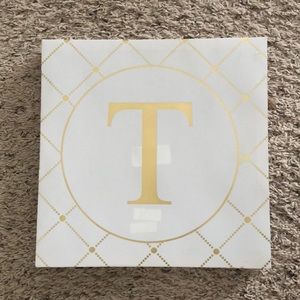 Gold and White letter T on canvas